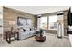 Modern living room with a comfortable sectional sofa, stylish wood accent wall, and bright windows at 1725 Hemlock Cir, Greenfield, IN 46140