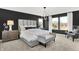 Luxurious main bedroom with a plush bed, statement lighting, and bright windows with a view at 1725 Hemlock Cir, Greenfield, IN 46140