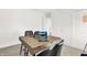 Bright home office featuring a large wooden desk with two laptops, comfortable chairs, and a sliding door at 1725 Hemlock Cir, Greenfield, IN 46140