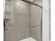This shower features light gray tiling, glass door, and a built-in shelf at 1725 Hemlock Cir, Greenfield, IN 46140