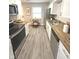 Well-lit kitchen with stainless steel appliances, wood countertops, white cabinets, and a cozy dining area at 1801 Bauer Rd, Indianapolis, IN 46218