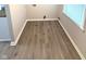Laundry room with modern flooring, ample light from the window, and washer/dryer hookups at 1801 Bauer Rd, Indianapolis, IN 46218