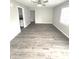 Spacious living room with neutral walls and wood-look flooring, bathed in natural light from a window at 1801 Bauer Rd, Indianapolis, IN 46218