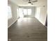Inviting living room with neutral paint, wood-look floors, and a bright window at 1801 Bauer Rd, Indianapolis, IN 46218