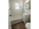 Functional bathroom with tub and tiled walls at 1844 N Riley Ave, Indianapolis, IN 46218
