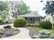 Charming home featuring an inviting walkway, awning, and well-maintained landscaping at 1844 N Riley Ave, Indianapolis, IN 46218
