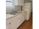 Classic kitchen featuring white cabinets and neutral countertops at 1844 N Riley Ave, Indianapolis, IN 46218
