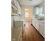 Galley kitchen featuring white cabinets and stainless steel sink at 1844 N Riley Ave, Indianapolis, IN 46218