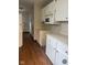 Functional kitchen featuring white cabinets and microwave at 1844 N Riley Ave, Indianapolis, IN 46218
