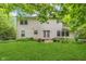 Spacious backyard with mature trees, a lawn, and a two-story home in the background at 19061 Fairfield Blvd, Noblesville, IN 46060