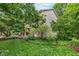 Well-manicured front yard featuring mature trees and lush landscaping at 19061 Fairfield Blvd, Noblesville, IN 46060