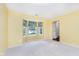 Bright living room featuring a bay window with floral curtains and neutral carpeting at 19061 Fairfield Blvd, Noblesville, IN 46060