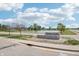 Community sign for Twelve Oaks, with pond and green space on a sunny day at 1961 Black Oak Dr, Shelbyville, IN 46176