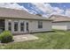 The home's exterior is showcased in this backyard view, featuring a patio and well-manicured lawn at 2025 Flamingo Way, Franklin, IN 46131