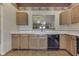 View of kitchen with light wood cabinets, dishwasher, and pass through to another room at 2025 Flamingo Way, Franklin, IN 46131