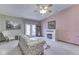 Cozy living room features a fireplace, floral sofa, and access to the outdoors at 2025 Flamingo Way, Franklin, IN 46131