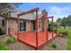 Backyard deck featuring a bright red stain and brick siding at 2027 Round Barn Ct, Anderson, IN 46017