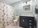 Bathroom with tiled floor, black vanity, and patterned shower curtain at 2027 Round Barn Ct, Anderson, IN 46017