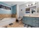 Bathroom featuring a large tub, a tiled floor, and a vanity with a light blue cabinet at 2027 Round Barn Ct, Anderson, IN 46017