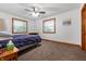 Carpeted bedroom with two windows, a ceiling fan, and neutral paint at 2027 Round Barn Ct, Anderson, IN 46017