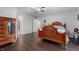 Bedroom with hardwood floors, ceiling fan, and ensuite bathroom with walk-in closet at 2027 Round Barn Ct, Anderson, IN 46017