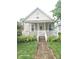 Charming home featuring a cozy front porch, a well-manicured lawn, and inviting curb appeal at 208 E Madison E St, Alexandria, IN 46001