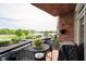 Outdoor balcony with a table, chairs, and a grill, perfect for enjoying the scenic view of the surrounding landscape at 20971 Shoreline Ct # 201, Noblesville, IN 46062