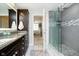 Bathroom showcasing a double vanity with granite countertops, and a glass-enclosed shower at 20971 Shoreline Ct # 201, Noblesville, IN 46062
