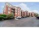 A brick condo building featuring multiple balconies and ample parking space at 20971 Shoreline Ct # 201, Noblesville, IN 46062