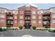 A brick condo building featuring multiple balconies and front entrance access at 20971 Shoreline Ct # 201, Noblesville, IN 46062