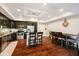 Open concept kitchen with hardwood floors and island seating, flowing into dining area at 20971 Shoreline Ct # 201, Noblesville, IN 46062
