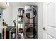 Convenient laundry room featuring a modern stacked washer and dryer, shelving, and plenty of storage space at 20971 Shoreline Ct # 201, Noblesville, IN 46062