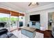 Cozy living room featuring access to the balcony, a large television, and a comfortable seating area at 20971 Shoreline Ct # 201, Noblesville, IN 46062