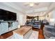 Bright living room with a large TV and entertainment center, a comfortable sofa, and an open view of the kitchen at 20971 Shoreline Ct # 201, Noblesville, IN 46062