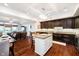Open layout with kitchen island, dining, and spacious living room with balcony access at 20971 Shoreline Ct # 201, Noblesville, IN 46062