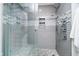 Modern shower with glass enclosure, stylish tile work, and multiple shower heads at 20971 Shoreline Ct # 201, Noblesville, IN 46062