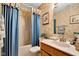Well-lit bathroom featuring a shower/tub combo and vanity with a large mirror at 2163 Bradford Trace Blvd, Indianapolis, IN 46229