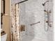 Bright bathroom featuring a marble-look shower, grab bar, and convenient built-in seat and shelves at 2163 Bradford Trace Blvd, Indianapolis, IN 46229