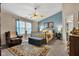 Primary bedroom with a stylish bed, seating area, and ample natural light at 2163 Bradford Trace Blvd, Indianapolis, IN 46229