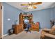 Cozy bedroom featuring a ceiling fan, built-in desk, and a comfortable chair at 2163 Bradford Trace Blvd, Indianapolis, IN 46229