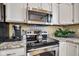 Modern kitchen with stainless steel appliances, granite countertops, and white cabinetry at 2163 Bradford Trace Blvd, Indianapolis, IN 46229