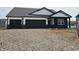 New construction home with a three car garage and modern black and white design at 2339 Pine Valley Dr, Plainfield, IN 46168