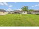 Expansive backyard with lush green grass, shed, and enclosed sunroom at 2445 S Bolton Ave, Indianapolis, IN 46203