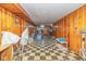A spacious basement with checkered flooring and wood paneled walls, offering room for activities and storage at 2445 S Bolton Ave, Indianapolis, IN 46203