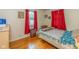 Bedroom showcasing hardwood floors, a window, and red curtains complementing the room's decor at 2445 S Bolton Ave, Indianapolis, IN 46203