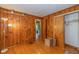 Bedroom featuring paneled walls, hardwood floors, and closet space at 2445 S Bolton Ave, Indianapolis, IN 46203
