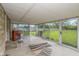 Bright sunroom with walls of windows offering serene backyard views and concrete flooring at 2445 S Bolton Ave, Indianapolis, IN 46203