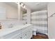 Elegant bathroom features a double sink vanity and a modern shower with a gray and white striped curtain at 246 Westchester Blvd, Noblesville, IN 46062