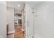 Beautifully remodeled bathroom with a shower, storage shelves, and brown floors at 246 Westchester Blvd, Noblesville, IN 46062