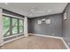 Bright bedroom with neutral carpet, a ceiling fan, a large window and grey walls at 246 Westchester Blvd, Noblesville, IN 46062